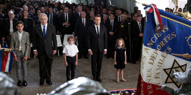 Israeli Prime Minister Benjamin Netanyahu and French President Emmanuel Macron, pay their respects after laying a wreath at the Vel d'Hiv memorial, during a ceremony commemorating the 75th anniversary of the Vel d'Hiv roundup, in Paris