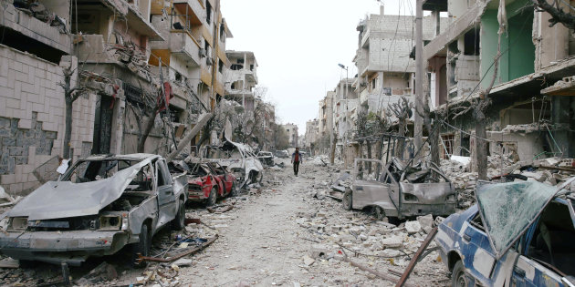Damaged cars and buildings are seen in the besieged town of Douma, Eastern Ghouta, Damascus