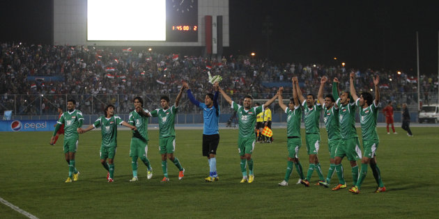 Iraq's players acknowledge their fans after their international friendly soccer match against Syria in Baghdad