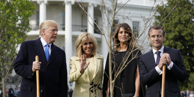 U.S. President Trump and first lady Melania Trump plant an oak tree sapling with French President Macron and his wife Brigitte on the South Lawn of the White House in Washington