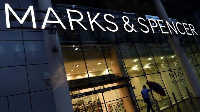 FILE PHOTO: A man leaves a Marks & Spencer store in London