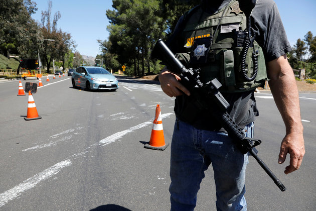 Police secure the scene of a shooting incident at the Congregation Chabad synagogue in Poway
