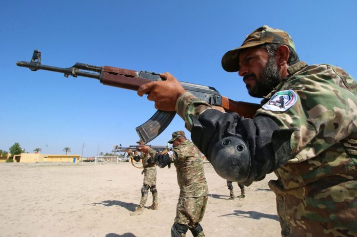 members of the paramilitary Popular Mobilisation Forces take part in a weapons training at their camp in Basra