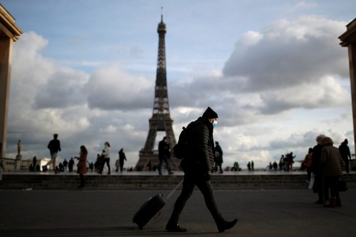 People wear protective face masks in Paris