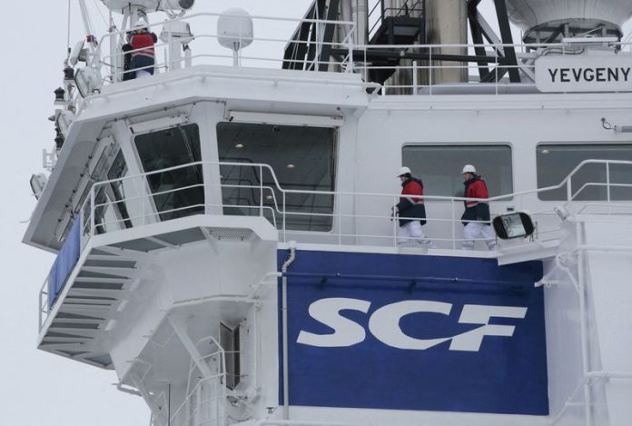 FILE PHOTO: The logo of Russian state shipping company Sovcomflot is seen on the multifunctional icebreaking standby vessel